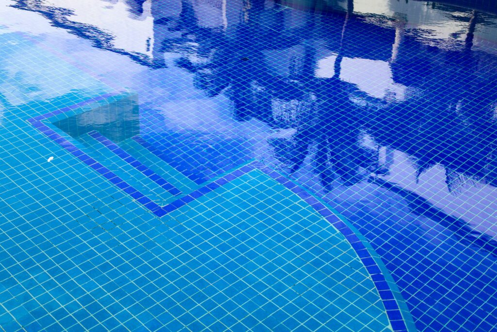Waterline tile and pool steps under clear water