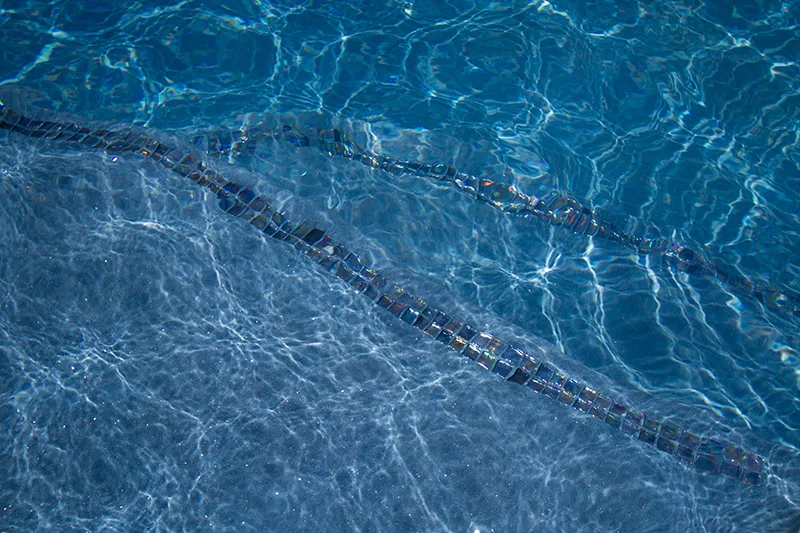 Close-up of NPT QuartzScapes Reflections Series pool finish, color Barbados Blue
