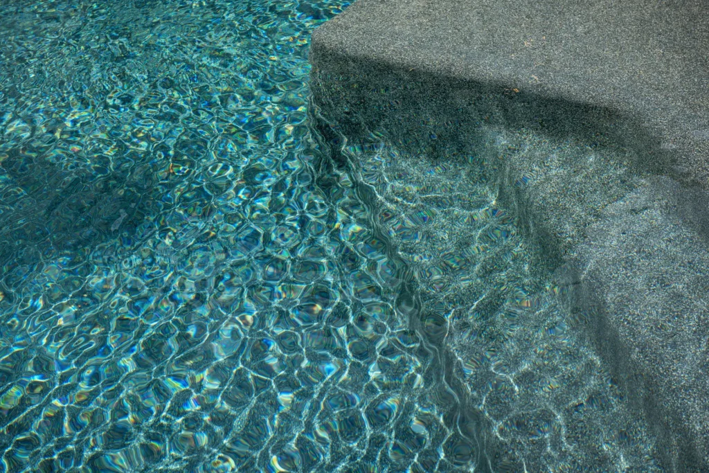 Close-up of NPT StoneScapes Mini Pebbles pool finish, color Rubicon Bay